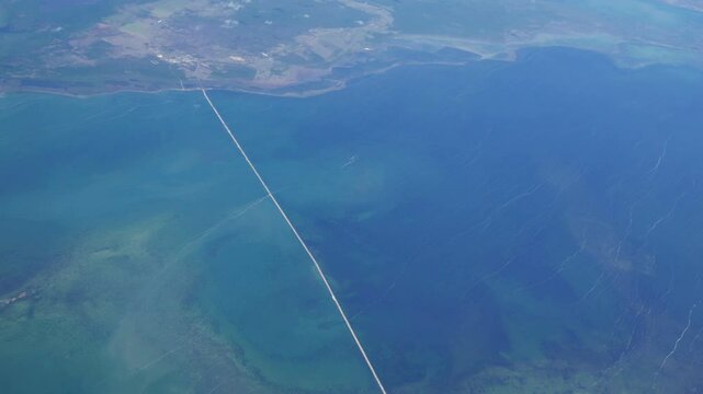 Aerial shot from a commercial airline over Cuba. Over the Bay of Dogs, Bahia de Perros, with the long causeway to Cayo Coco seen.