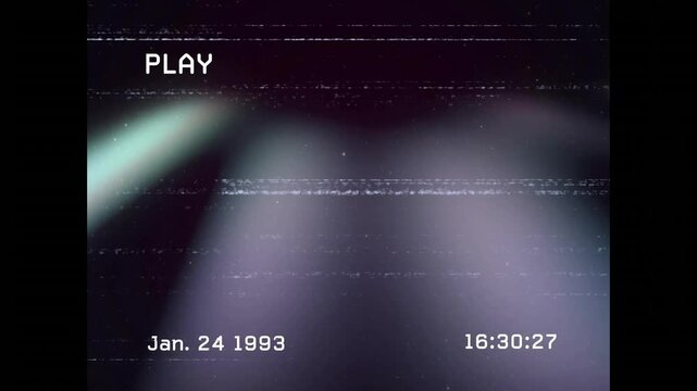 Overlay displaying PLAY and date stamp initiating colored beams shifting and merging in VHS glitch
