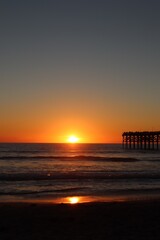 Beautiful orange yellow sunset over pacific beach boardwalk