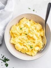Creamy Scrambled Eggs Served in a Rustic Bowl with Parsley Garnish