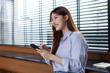 Beautiful Asian female has transfer money financial internet banking on mobile phone, asian woman...