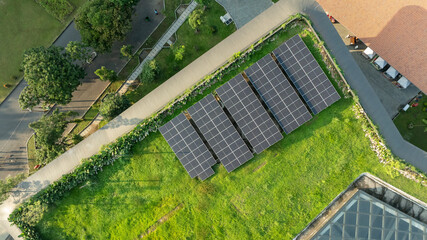 Aerial View of Green Rooftop Solar Panels Installation on Eco-Friendly Building with Lush...