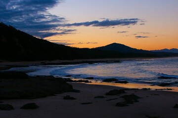 Sunset over evening waves at Nambucca Heads in New South Wales Australia