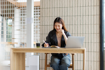 Business freelance young adult asian woman using laptop at cafe
