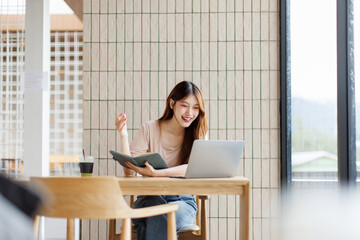 Beautiful confident asian business woman working with laptop. business planning in office....