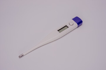 A sleek digital thermometer isolated on a white background. Designed for accurate body temperature measurement, it features a metallic tip and an LCD screen for clear readings.