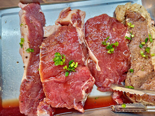 Raw Striploin Steak Meat on a Tray.