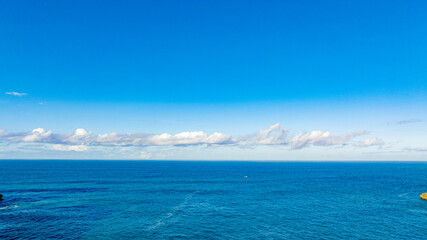 Vast Ocean Panorama Under a Clear Blue Sky: A Serene Coastal View