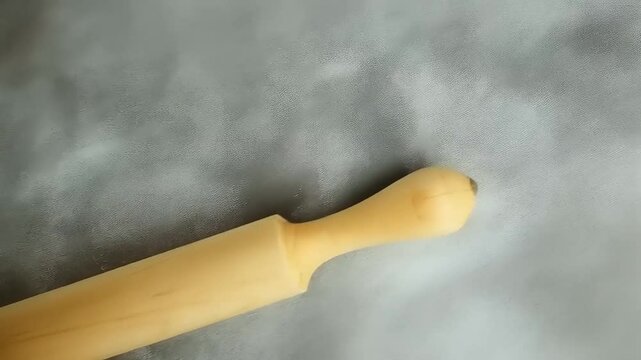 Wooden Rolling Pin on Gray Surface: Baking Tool
