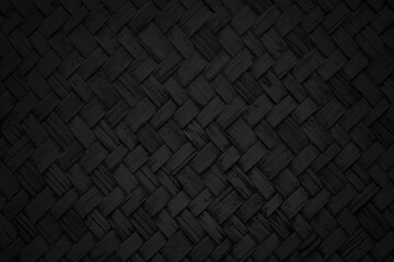Old black bamboo weaving pattern, woven rattan mat texture for background and design art work.