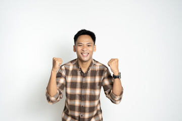 Cheerful Man Celebrating with Raised Fists in Excitement and Confidence