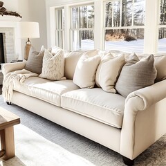 White couch with pillows and a blanket on it