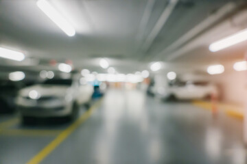 Bokeh for background. Blurred View of Modern Parking Garage at Night with Vehicle Silhouettes and...
