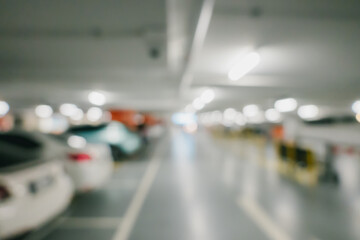 Bokeh for background. Blurred Interior of a Modern Parking Garage with Illuminated Spaces and...