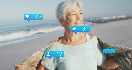Woman wearing shawl gazing on beach causing social media reaction icons showing rising engagement - Powered by Adobe