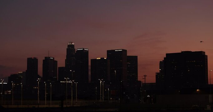 Los Angeles, California, USA - June 10, 2025: A LAPD police helicopter flies over the Downtown Federal Building and ICE deportation protests in Downtown LA. 
