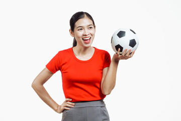 Confident young Asian woman in vibrant red shirt stands against white background, cheering joyfully...