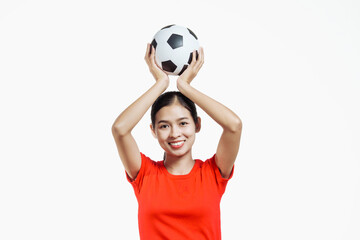 Confident young Asian woman in vibrant red shirt stands against white background, cheering joyfully...