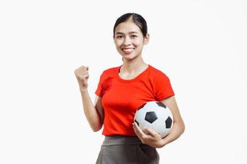 Confident young Asian woman in vibrant red shirt stands against white background, cheering joyfully...