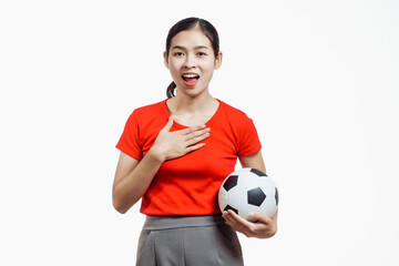 Confident young Asian woman in vibrant red shirt stands against white background, cheering joyfully...