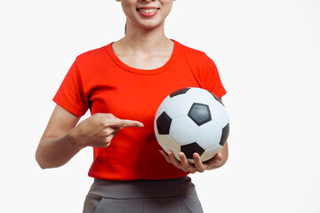 Confident young Asian woman in vibrant red shirt stands against white background, cheering joyfully...