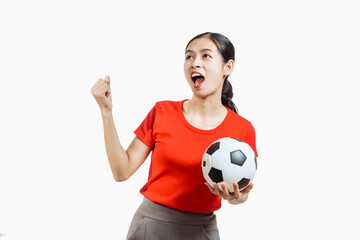 Confident young Asian woman in vibrant red shirt stands against white background, cheering joyfully...