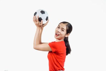 Confident young Asian woman in vibrant red shirt stands against white background, cheering joyfully...