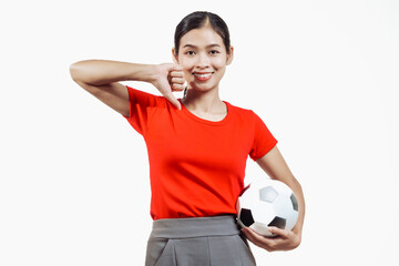 Confident young Asian woman in vibrant red shirt stands against white background, cheering joyfully...