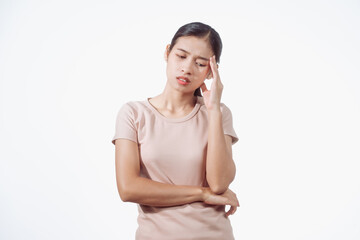 Confident young Asian woman in light brown shirt stands against white background, experiencing...