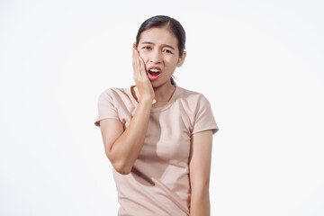 A confident young Asian woman in a light brown shirt stands against white background, experiencing...