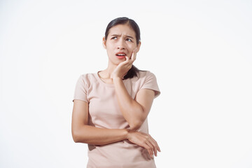 A confident young Asian woman in a light brown shirt stands against white background, experiencing...