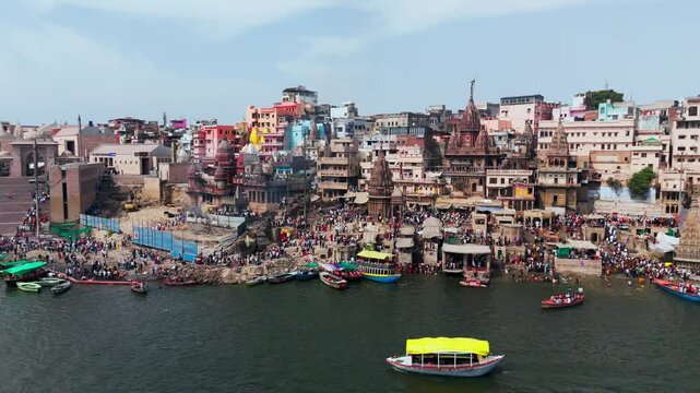 Varanasi, Uttar Pradesh, India-25th February 2025- 
Aerial view drone shot of Varanasi ghat area, showing Ganga River widely spread and huge number of row boats flowing through the river.
