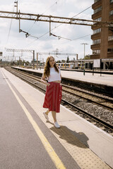 Portrait of a woman walking in a train station