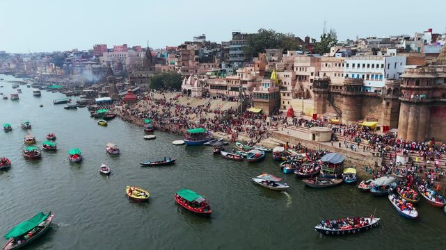 Varanasi, Uttar Pradesh, India-25th February 2025- 
Aerial view drone shot of Varanasi ghat area, showing Ganga River widely spread and huge number of row boats flowing through the river.