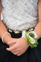 Girl Wearing Floral Corsage and Lace Dress at Formal Event