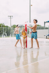 Energetic kids playing together at urban splash pad © Cavan