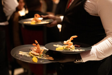 Waiters serving entrees in a restuarant