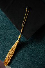 close-up of a golden graduation tassel on a graduation cap