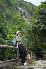 Woman resting against the railing on the way up the mountain