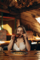 Woman Enjoying a Delicious Meal in a Cozy Rustic Restaurant Setting