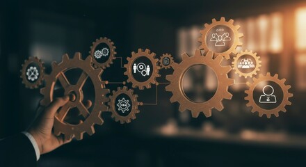 Hand interacting with interconnected gears, representing teamwork and collaboration in a business setting