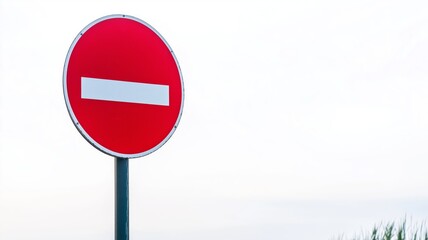 Traffic sign indicating no entry in urban area during overcast weather conditions