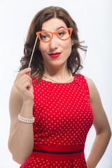 Portrait of Surprised Caucasian Brunette Woman With Artistic Spectacles In Front Of Face.Against White.