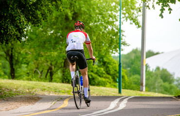 Cyclist ride on the bike path in the city Park
