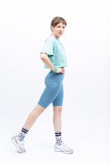 Sport Indoor Concepts. One Sexy Sportive Caucasian Female During Legs and Torso Musles Body and Back Stretching Exercises Posing Over White.