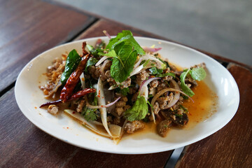 Close up dish of Larb, spicy minced pork salad- Thai recipe