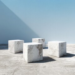 Four white marble cubes on light gray concrete floor