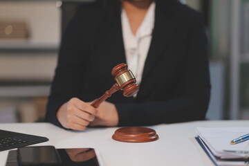 Judge gavel with Justice lawyers having team meeting at law firm background. Concepts of Law and...
