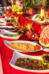 Traditional Turkish cuisine - stuffed peppers, eggplant stew salad with yogurt, sweet potato, various cheese slices, stewed beans, grilled vegetables, carrot salad, broccoli