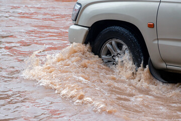 Heavy rain causes urban flooding as water covers streets, disrupting daily life and transportation.